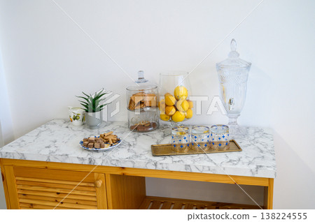 Charming display of treats and decor on a marble topped dining table Charming display of treats and decor on a marble topped dining table 138224555