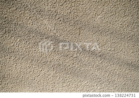 Textured wall illuminated by soft sunlight, showcasing intricate patterns and subtle shadows Textured wall illuminated by soft sunlight, showcasing intricate patterns and subtle shadows 138224731