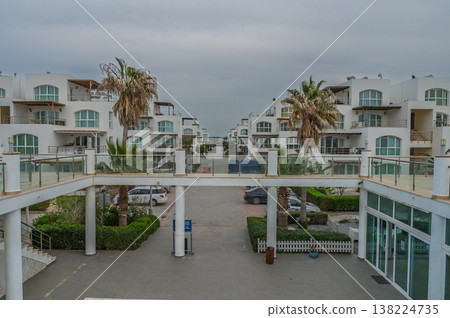 Modern coastal architecture featuring palm trees and serene atmosphere in a tranquil neighborhood Modern coastal architecture featuring palm trees and serene atmosphere in a tranquil neighborhood 138224735
