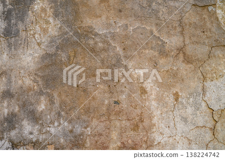 Weathered wall texture showcasing natural colors and cracks from years of exposure in an urban environment Weathered wall texture showcasing natural colors and cracks from years of exposure in an urban environment 138224742
