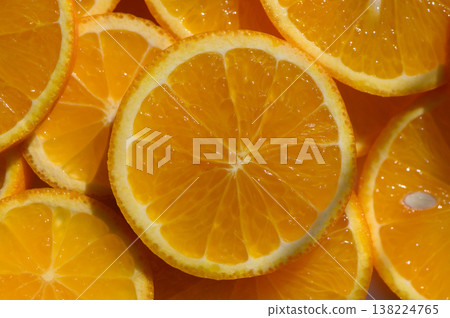 Bright orange citrus slices arranged artfully on a white surface in a vibrant Bright orange citrus slices arranged artfully on a white surface in a vibrant 138224765