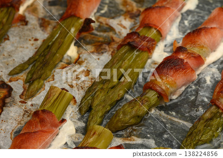 Crunchy asparagus wrapped in savory bacon, fresh from the oven during a cozy 138224856