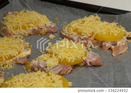 Juicy chicken breasts topped with pineapple and shredded cheese on a baking 138224932