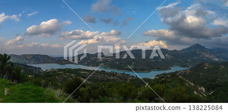 Serene lake view with rolling hills under a dreamy sky in early evening light Serene lake view with rolling hills under a dreamy sky in early evening light 138225084