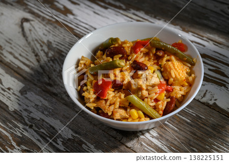 Savory rice dish with chicken, vegetables, and spices served in a bowl Savory rice dish with chicken, vegetables, and spices served in a bowl 138225151