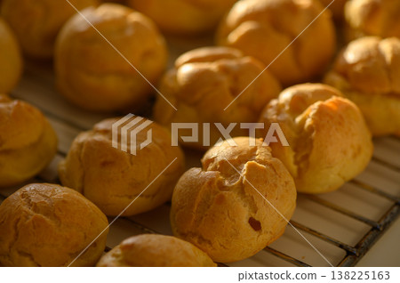 Golden pastries cool on a rack in a warm kitchen filled with delightful aromas Golden pastries cool on a rack in a warm kitchen filled with delightful aromas 138225163
