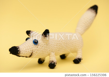 Handmade Knitted White Dog on Yellow Background Handmade Knitted White Dog on Yellow Background 138225306