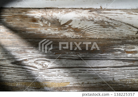 Sunlight playing on weathered wooden floor with unique textures and patterns 138225357