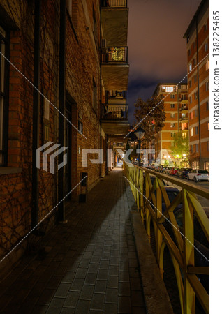 Night Brick Alley Illuminated by a Single Lamp. Minimalist Play of Light and Shadow. Night Brick Alley Illuminated by a Single Lamp. Minimalist Play of Light and Shadow. 138225465