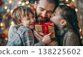 Father holding  gift with hug and kisses from son and daughter. 138225602