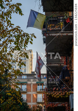 Ukrainian and Georgian Flags on Balconies in Urban Environment Ukrainian and Georgian Flags on Balconies in Urban Environment 138225694