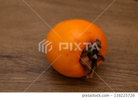Ripe Persimmon Fruits on Wooden Table Ripe Persimmon Fruits on Wooden Table 138225726