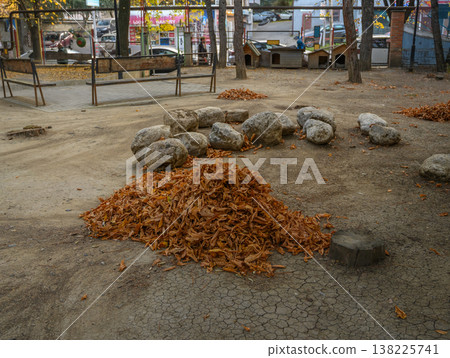 Raked Pile of Autumn Leaves by Roadside Raked Pile of Autumn Leaves by Roadside 138225741