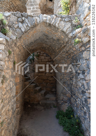 Stone room with narrow windows and arched ceiling inside Saint Hilarion Castle, showcasing medieval military architecture of Northern Cyprus. Stone room with narrow windows and arched ceiling inside Saint Hilarion Castle, showcasing medieval military architecture of Northern Cyprus. 138226162