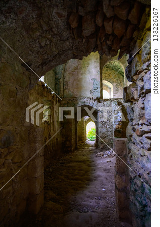 Soft light entering through a narrow window in Saint Hilarion Castle, casting shadows on textured medieval stone walls. Soft light entering through a narrow window in Saint Hilarion Castle, casting shadows on textured medieval stone walls. 138226167