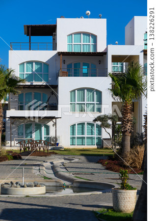 Stunning beachfront architecture showcases unique design and vibrant landscaping in a tropical paradise Stunning beachfront architecture showcases unique design and vibrant landscaping in a tropical paradise 138226291