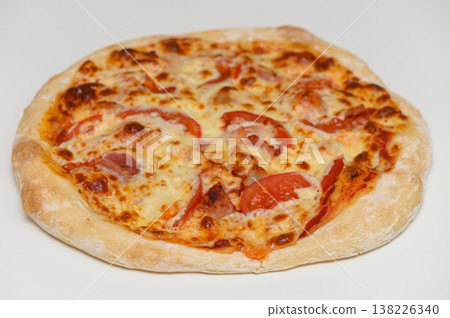 Rustic-style pizza topped with cheese, bacon, and tomato slices, fresh from the oven. Great for culinary websites and menus. Rustic-style pizza topped with cheese, bacon, and tomato slices, fresh from the oven. Great for culinary websites and menus. 138226340