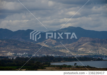 Stunning high angle landscape of the Mediterranean Sea meeting the coastal mountains in Cyprus on a bright sunny day. Stunning high angle landscape of the Mediterranean Sea meeting the coastal mountains in Cyprus on a bright sunny day. 138226417