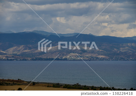 Breathtaking aerial view of Cyprus coastline with rocky mountains and turquoise sea under a clear blue sky. Perfect summer travel destination. Breathtaking aerial view of Cyprus coastline with rocky mountains and turquoise sea under a clear blue sky. Perfect summer travel destination. 138226418
