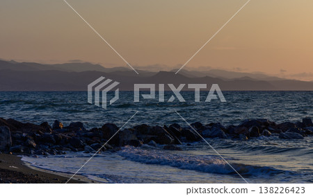 Stunning sunset over the calm Mediterranean Sea in Cyprus, with glowing clouds and warm golden light reflecting on the water. Stunning sunset over the calm Mediterranean Sea in Cyprus, with glowing clouds and warm golden light reflecting on the water. 138226423