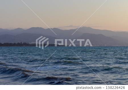 Vivid orange and pink sunset over a quiet beach in Cyprus, with gentle waves and warm evening light. Perfect peaceful moment by the sea. Vivid orange and pink sunset over a quiet beach in Cyprus, with gentle waves and warm evening light. Perfect peaceful moment by the sea. 138226426