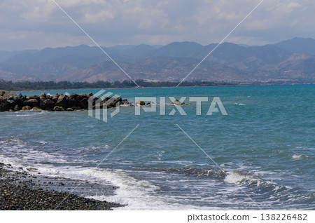 Sunny Mediterranean beach with clear blue sky and calm sea Sunny Mediterranean beach with clear blue sky and calm sea 138226482