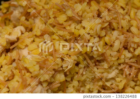 Authentic Cypriot meal of bulgur wheat mixed with small pasta and tender chicken pieces. Homemade comfort food rich in flavor and tradition. Authentic Cypriot meal of bulgur wheat mixed with small pasta and tender chicken pieces. Homemade comfort food rich in flavor and tradition. 138226488