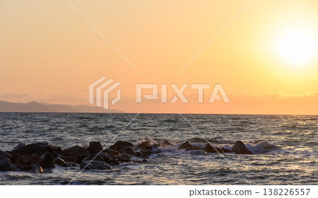 Sunset light bathes the rocky coastline of Cyprus in golden tones, with dramatic skies and shimmering reflections on the Mediterranean Sea. Sunset light bathes the rocky coastline of Cyprus in golden tones, with dramatic skies and shimmering reflections on the Mediterranean Sea. 138226557