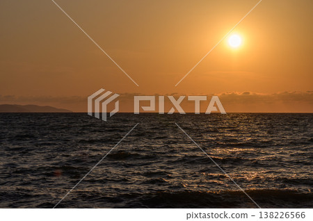 Fiery sunset lights up the sky and reflects on the calm waters of the Mediterranean Sea near the Cyprus shoreline. A stunning natural evening scene. Fiery sunset lights up the sky and reflects on the calm waters of the Mediterranean Sea near the Cyprus shoreline. A stunning natural evening scene. 138226566