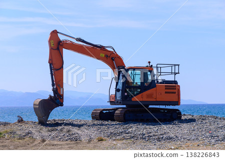 Orange Excavator on Seaside in Cyprus Orange Excavator on Seaside in Cyprus 138226843