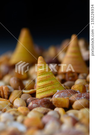 Colorful cones nestled among an array of earthy nuts create a whimsical landscape that sparks curiosity and delight Colorful cones nestled among an array of earthy nuts create a whimsical landscape that sparks curiosity and delight 138226934