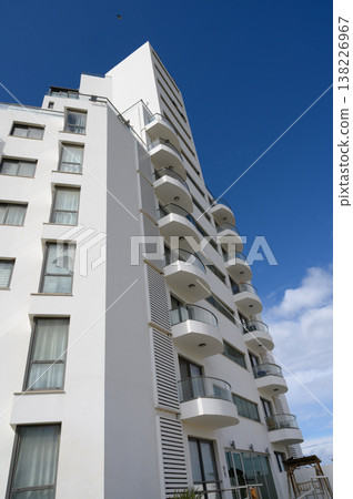 Modern architecture showcases sleek design in a vibrant urban setting under a clear blue sky 138226967