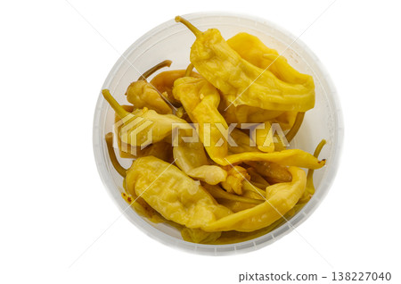 Canned chili peppers in plastic container on white background 138227040