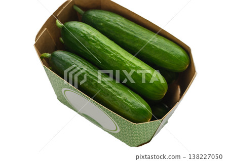 Mini cucumbers in cardboard box on white background Mini cucumbers in cardboard box on white background 138227050