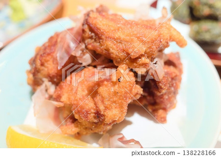 A plate of fried food featuring fried chicken. 138228166