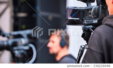 Cameraman filming video production with professional camera equipment on location 138228446