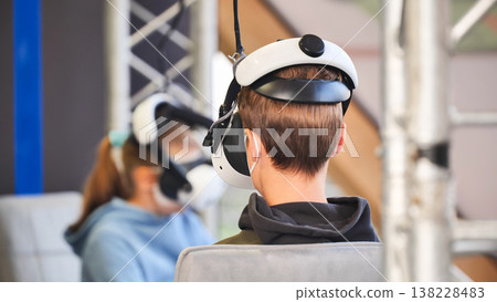 Young person experiencing virtual reality headset immersion Young person experiencing virtual reality headset immersion 138228483
