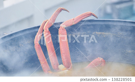 Crab legs cooking in a steaming pot, preparing a delicious seafood meal 138228501