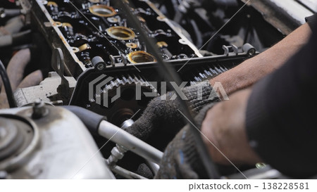 Mechanic working on car engine repair service Mechanic working on car engine repair service 138228581