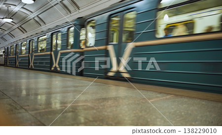 Moscow metro train moving fast through a station platform, blurring speed and transit 138229010