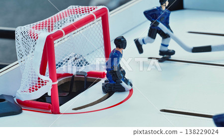Goalkeeper defending the net during table hockey game Goalkeeper defending the net during table hockey game 138229024
