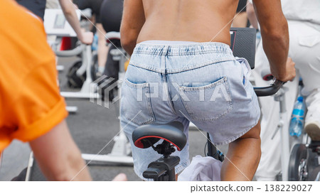 Athlete training on exercise bike during sports day competition Athlete training on exercise bike during sports day competition 138229027