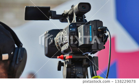Cameraman recording sport event with professional camcorder Cameraman recording sport event with professional camcorder 138229078