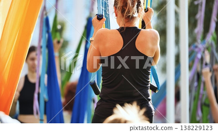 Woman performing aerial antigravity fly yoga at India Day festival in Moscow 138229123