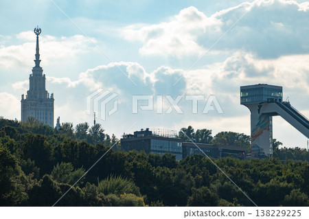 Moscow State University and Vorobyovy Gory ski jump overlooking a green treeline Moscow State University and Vorobyovy Gory ski jump overlooking a green treeline 138229225