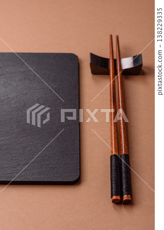 Wooden bamboo chopsticks for sushi and other Asian food with a blank background. Wooden chopsticks 138229335