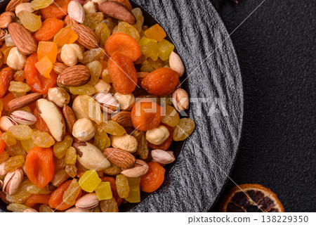 A mix of nuts and dried fruits as ingredients for a healthy meal. Nuts and dried fruits A mix of nuts and dried fruits as ingredients for a healthy meal. Nuts and dried fruits 138229350