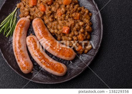 Lentil, carrot, and tomato stew with sausages, a European dish. Lentils with sausages 138229356