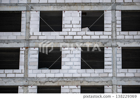 Building facade forming repetitive pattern with concrete beams and aerated blocks 138229369