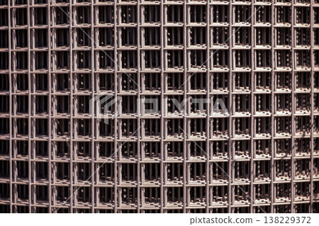 Metal wire mesh texture creating grid pattern for industrial background 138229372